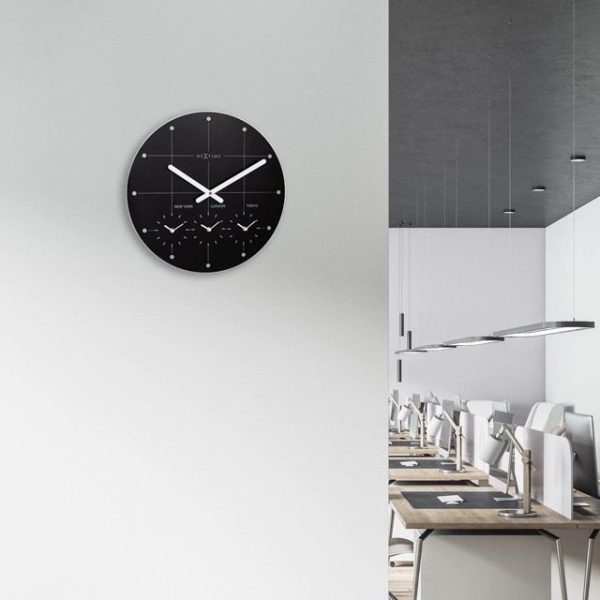 Black city wall clock shown in an office setting
