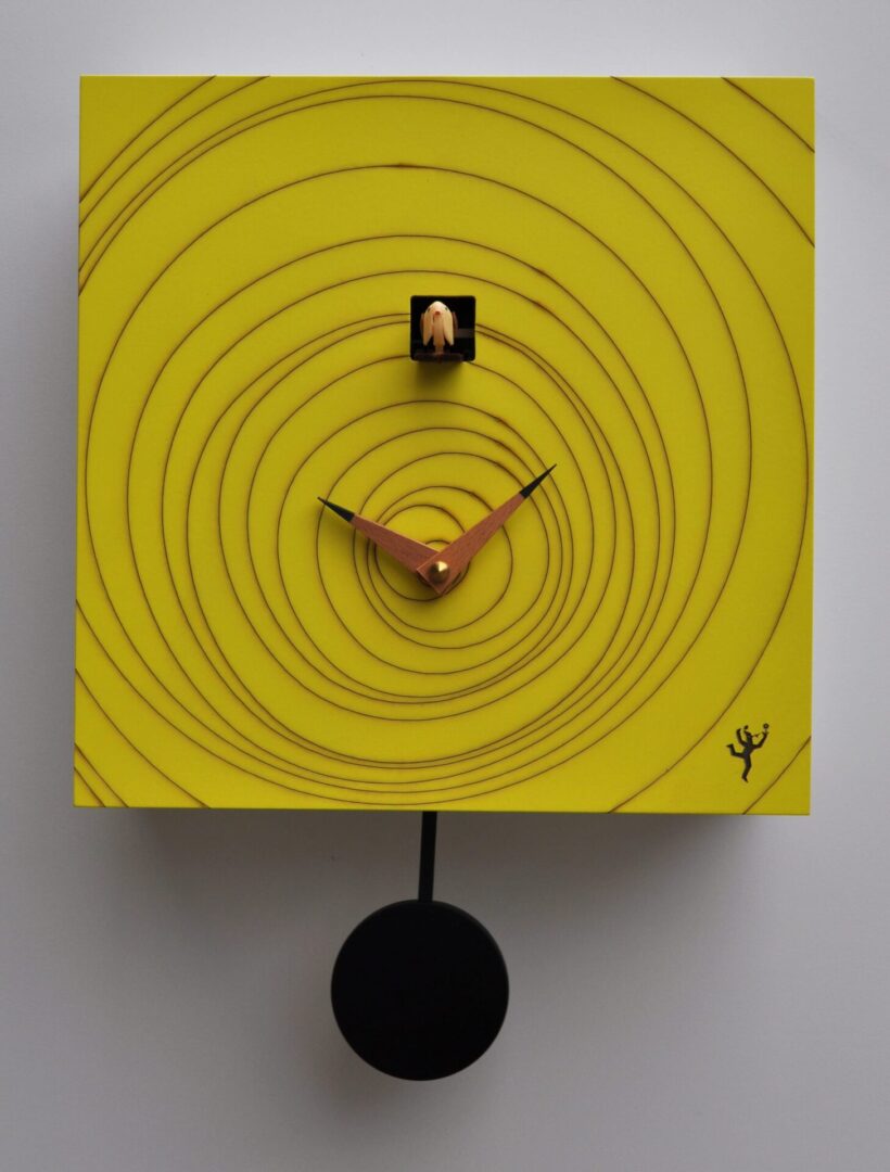 A square yellow cuckoo clock with a vortex design