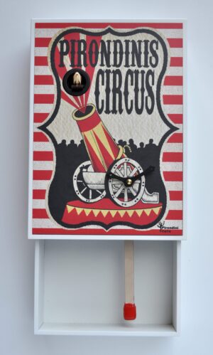 A fun and unusual cuckoo clock in the form of a matchbox, the image showing a circus cannon in retro style. The opened 'matchbox' has a match stick for a pendulum.