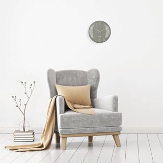 Shade wall clock shown in a room setting