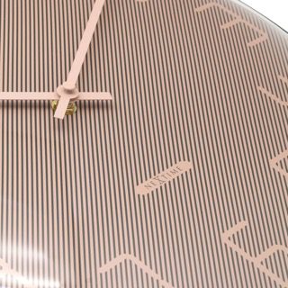 Close up of shade wall clock to show how the design works to highlight the numbers and hands