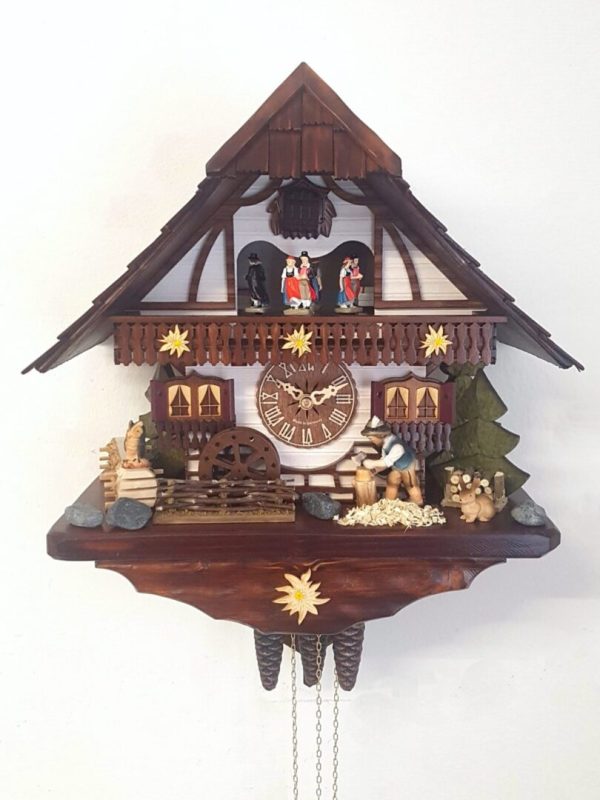 Musical Cuckoo Clock with a woodcutter chopping wood with his axe and a waterwheel infront of the chalet. Dancers turn on the balcony on the hour